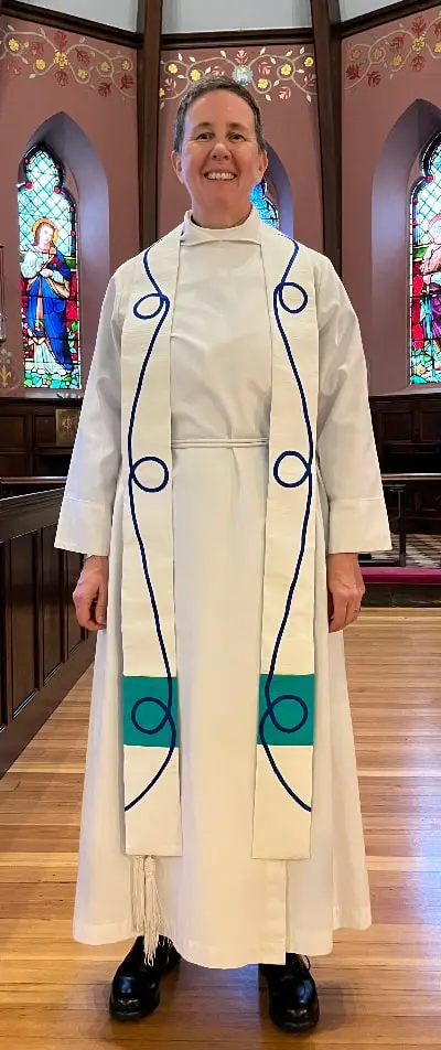 white clergy stole with blue scroll pattern