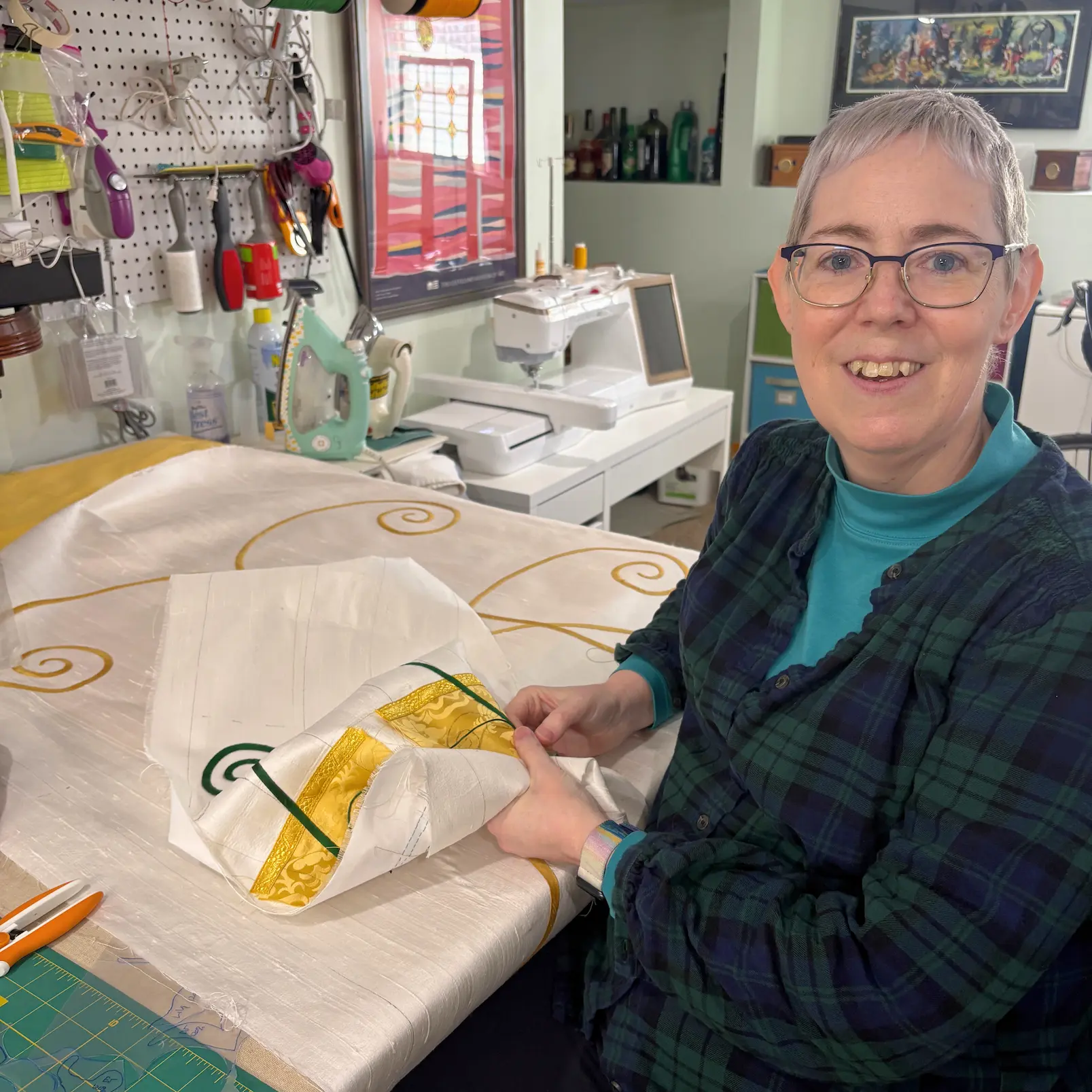 liturgical textile artist hand sewing custom altar paraments in studio