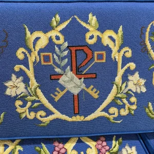 Detail of a blue kneeler with swirls and flowers, that inspired the parament design in Concord, NC