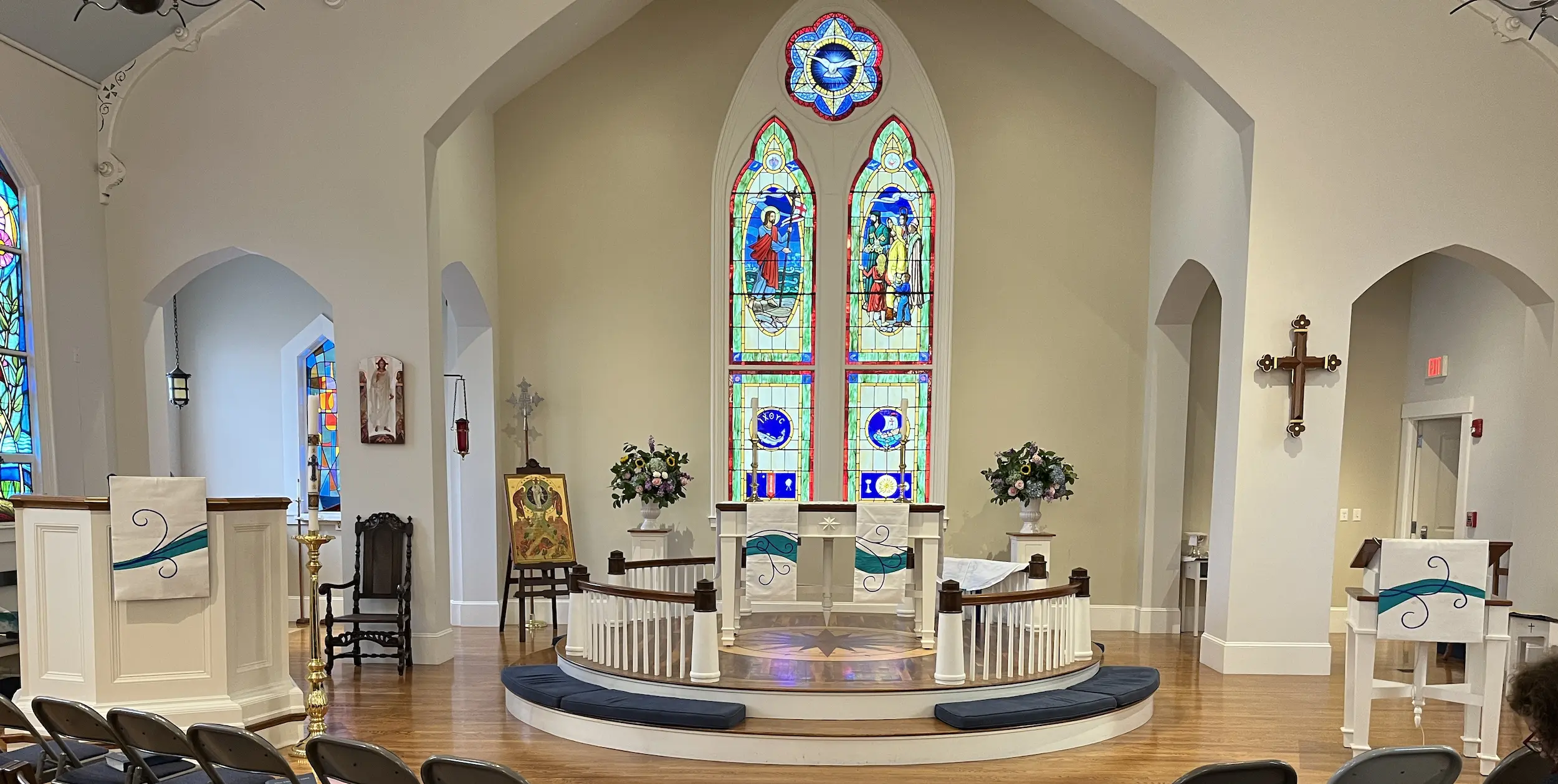 View of the chancel with coordinated paraments and stained glass windows