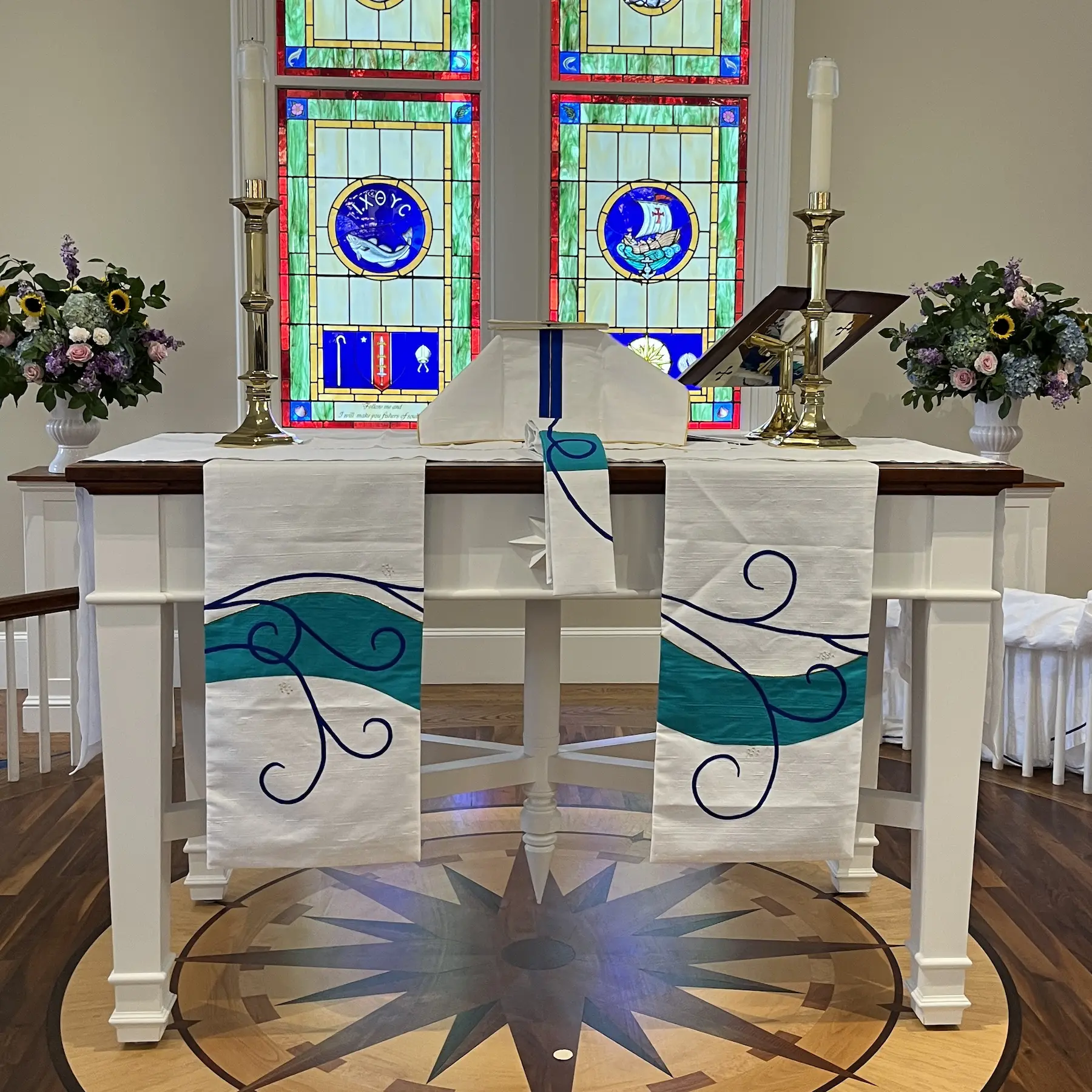 altar paraments with blue scroll and wave shape continued from the other paraments