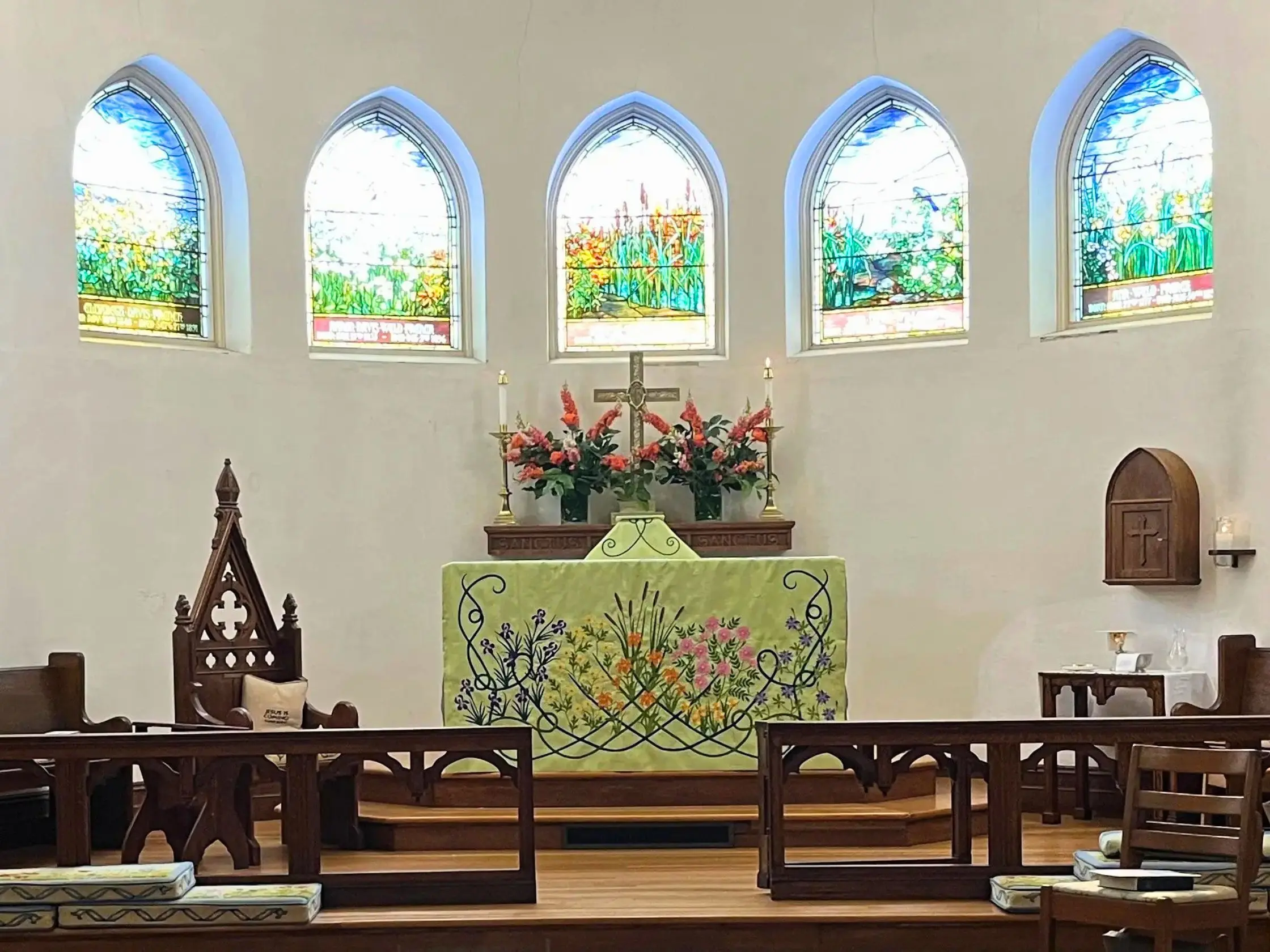 Nantucket chancel with the green floral altar cloth and floral stained glass windows