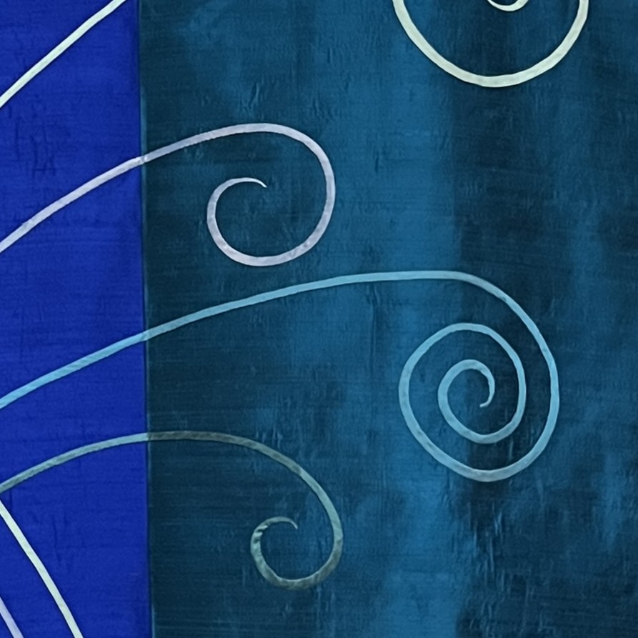 elaborate detail of bias appliqué, which has each stitch placed by hand.