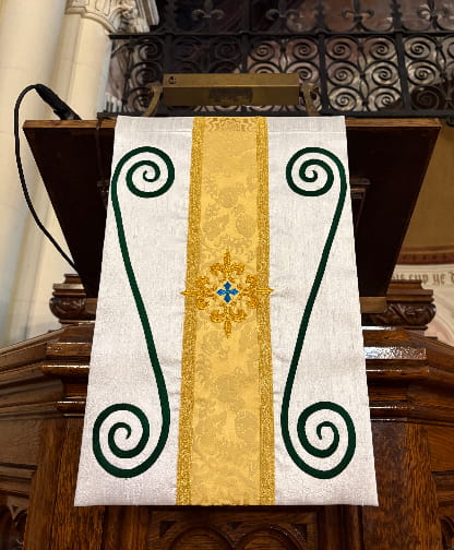 handmade pulpit fall with embroidered scrollwork displayed on eagle lectern