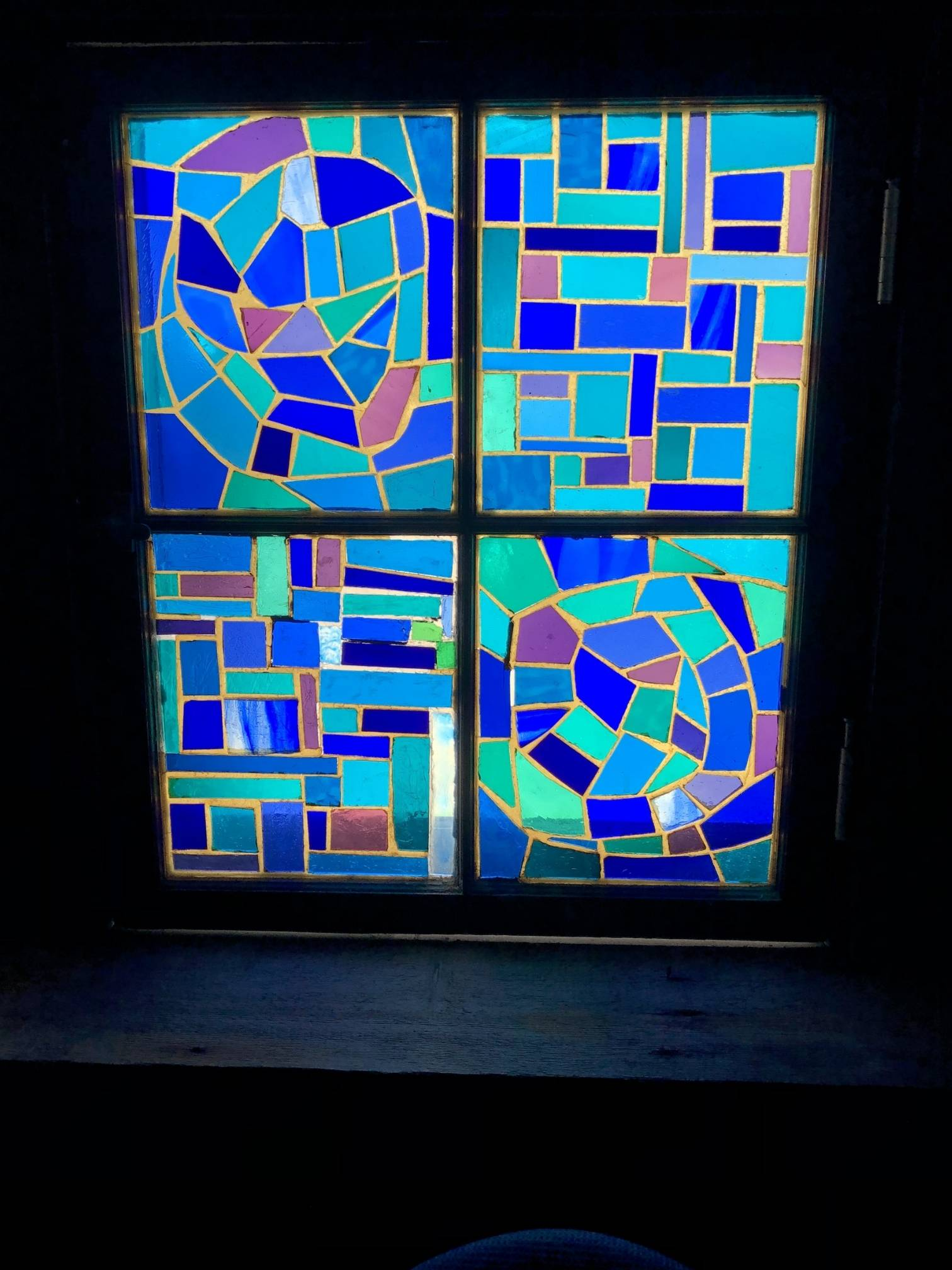 Blue seaglass-shaped windows at St. Mary's in Provincetown