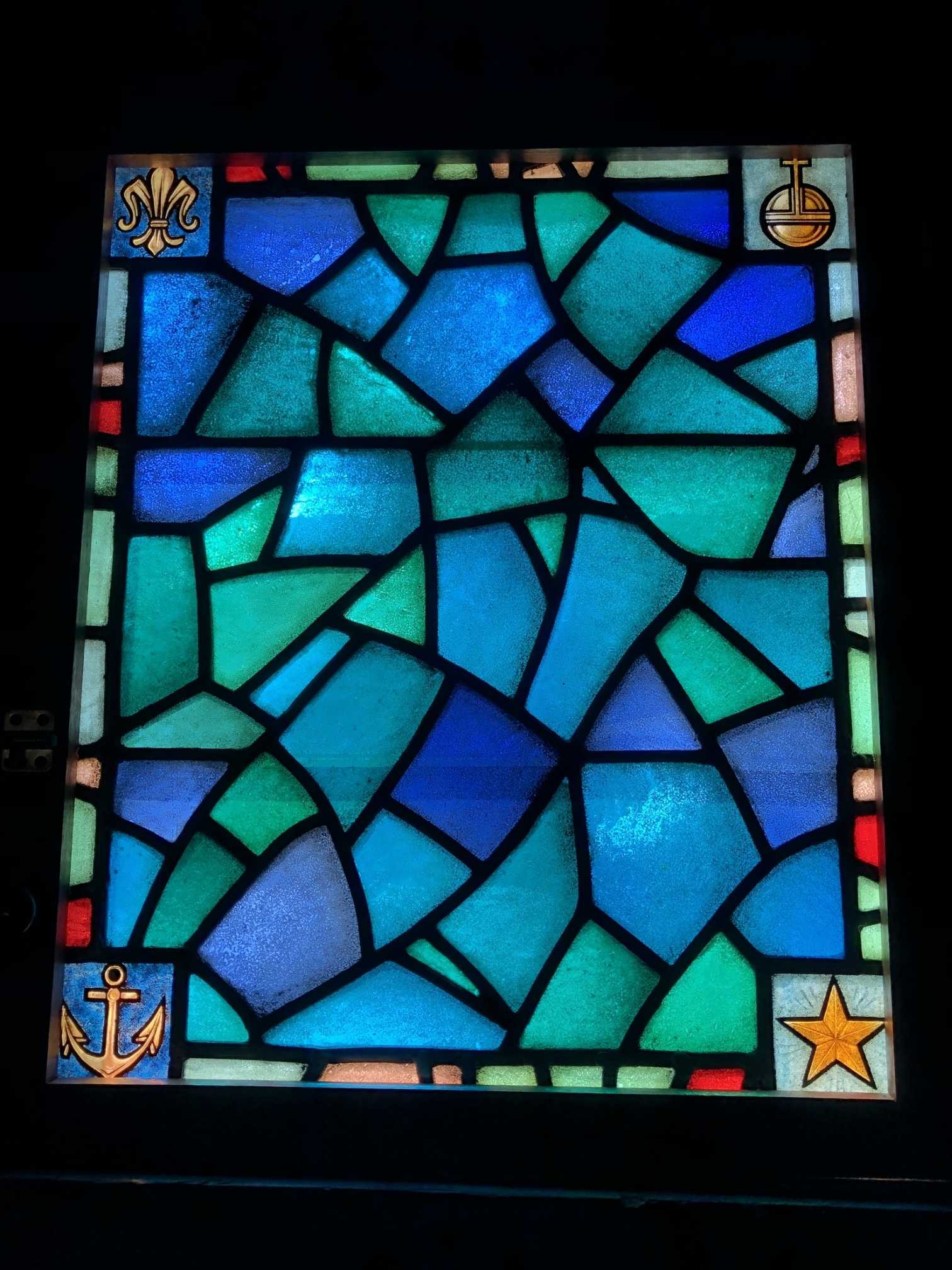Another blue seaglass-shaped windows at St. Mary's in Provincetown with nautical details in the corners.
