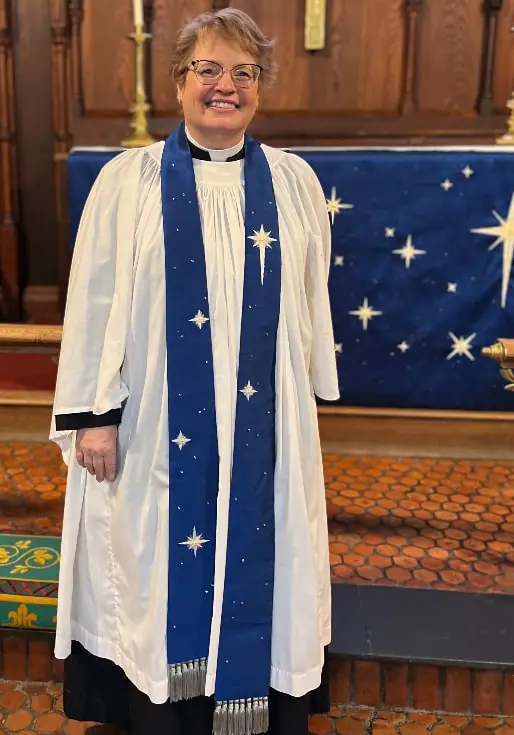 The priest in Dedham models her advent stole that coordinates with the custom altar cloth