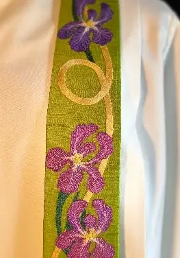 Detail of Christina's signature applique and thread painting technique with pink and purple florals and a swooping line