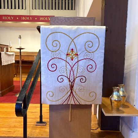 Red and gold scrolls embellish this pulpit fall in Reading, MA