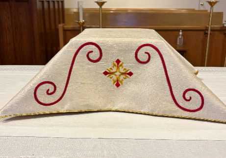 Eucharistic veil for Church of the Good Shepherd in Reading, MA, with red scrolls and a gold cross symbol.