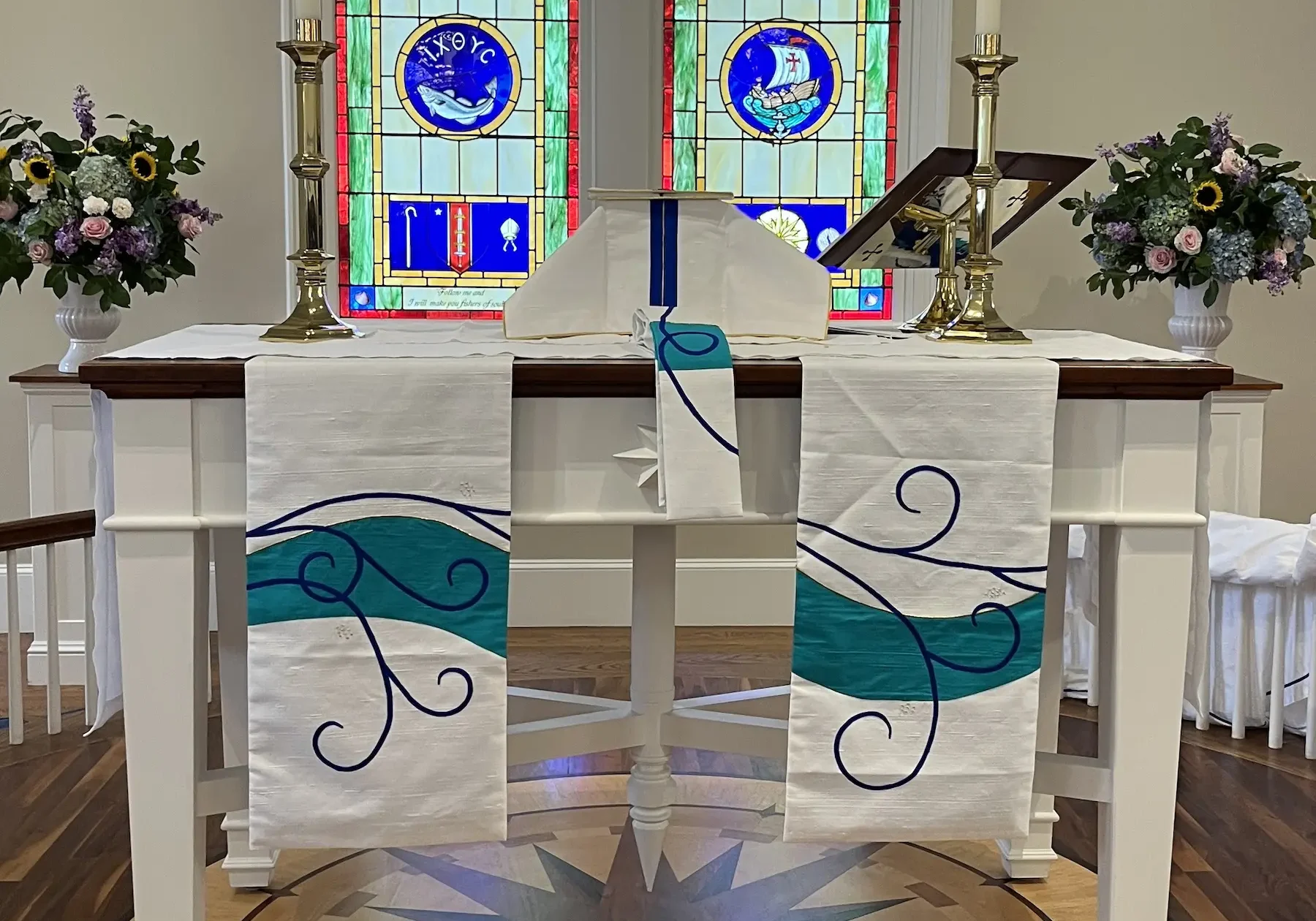 altar paraments with blue scroll and wave shape continued from the other paraments