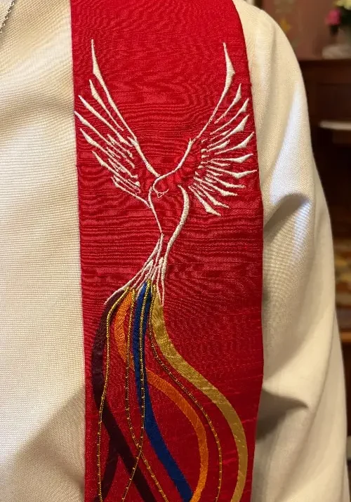 red clergy stole detail with dove and flame embroidery
