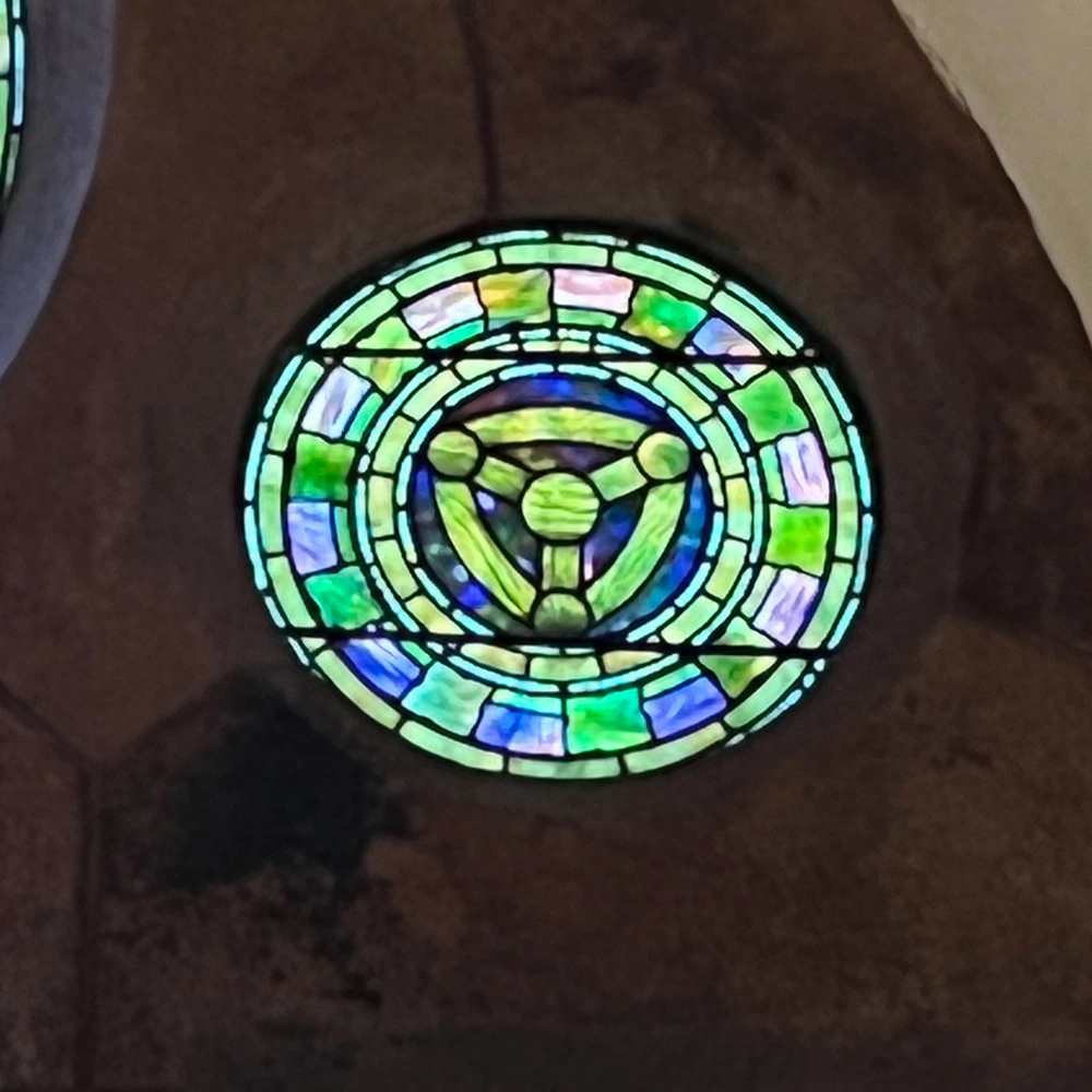 Church window detail that shows the trinity symbol used in the design