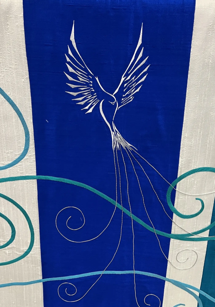 Detail of the dove, machine-embroidered from an original design, with silver couching