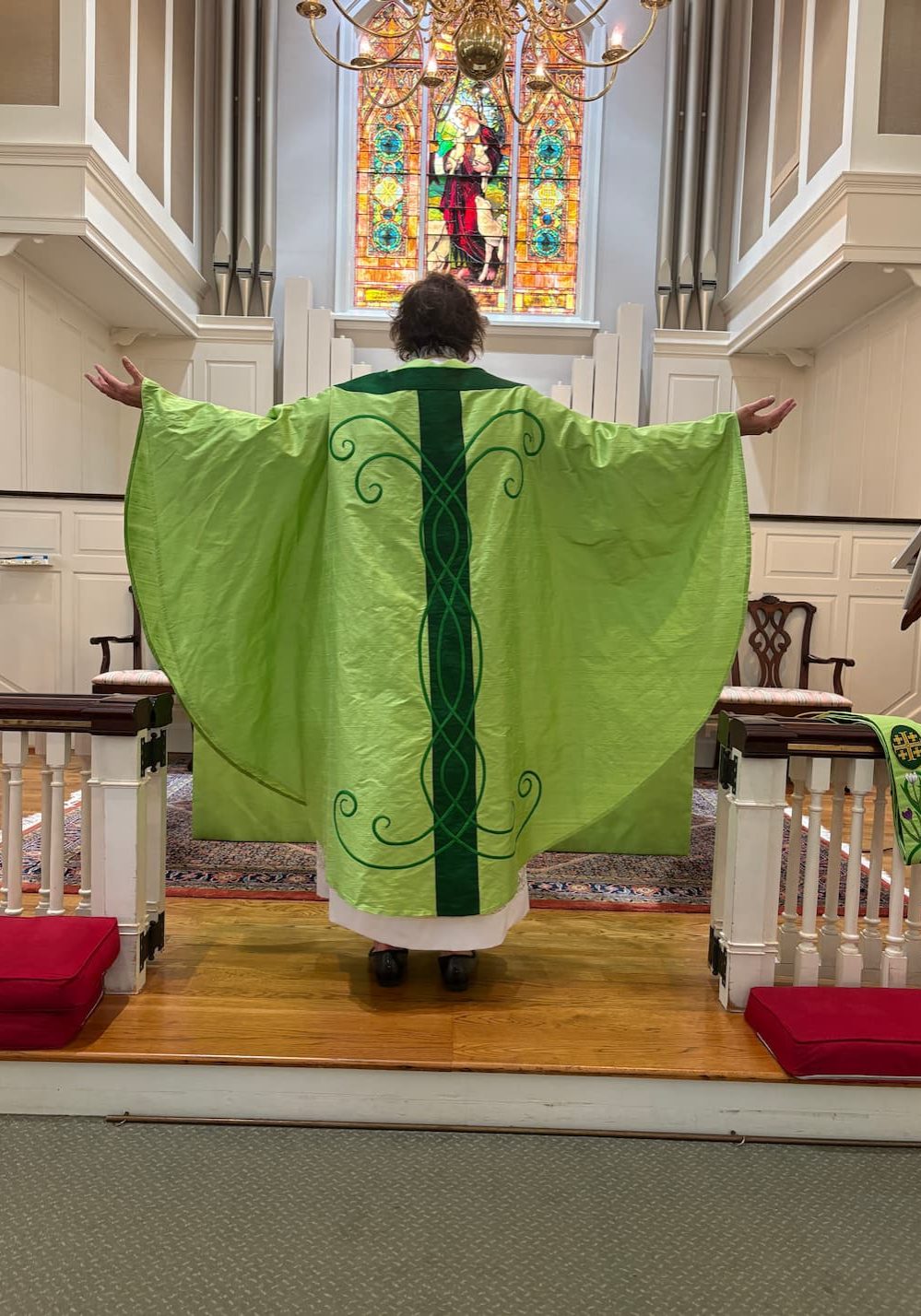 The back of the chasuble continues the scroll motif