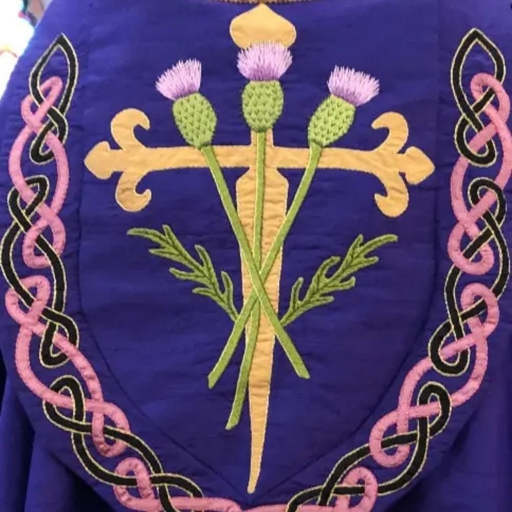 bespoke lenten cope detail with a cross, flowers, and Celtic knots