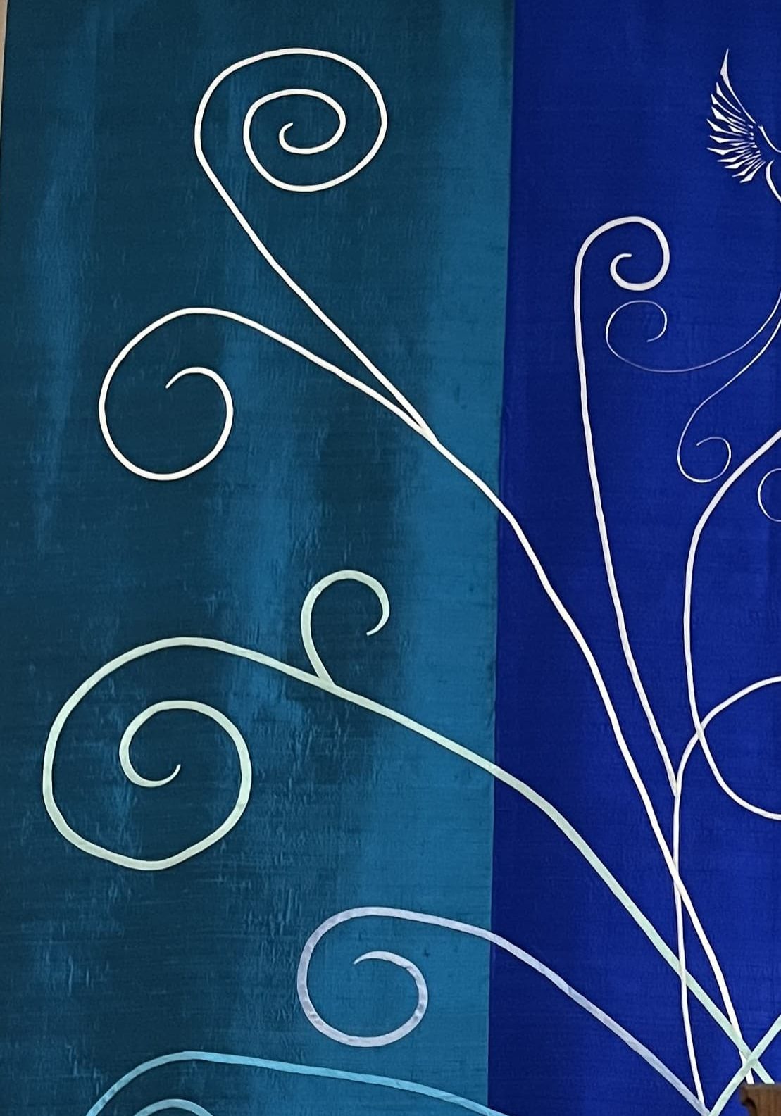 bias appliqué to in Christina's trademark “fiddlehead” designs.