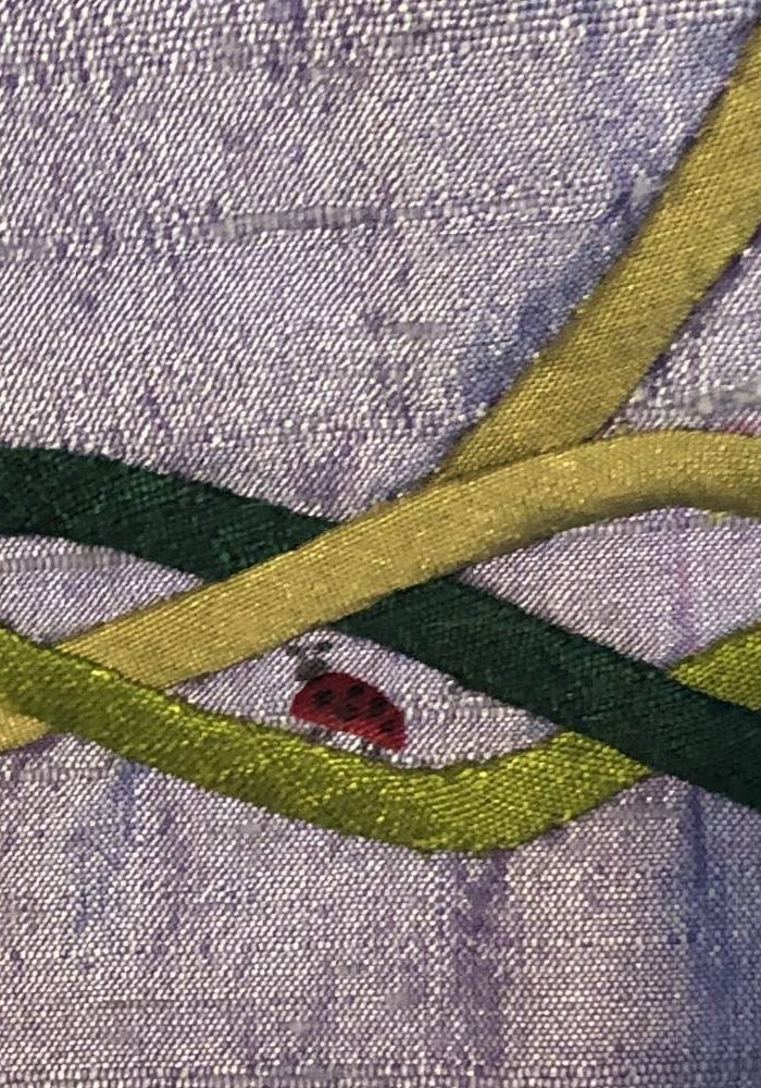 embroidered ladybug is a delightful detail in these custom paraments.